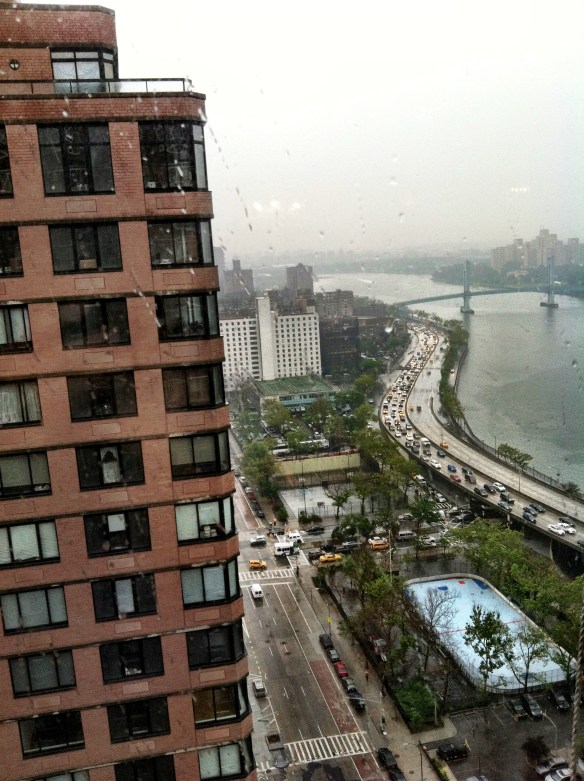 Looking at the rain and at the apartments across the street